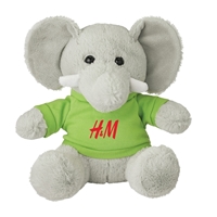 A plush gray elephant wearing a green shirt with "H&M" in red lettering. The elephant has large ears, a trunk, and a friendly appearance.