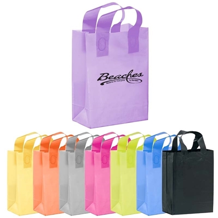 Colorful assortment of reusable shopping bags in various hues, including purple, yellow, orange, gray, pink, blue, and black. The purple bag features "Beaches" branding.