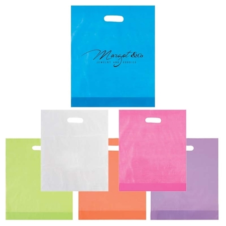 Colorful plastic bags with die-cut handles are stacked in a fan arrangement. The top bag is blue, featuring the text "Margot & Co Jewelry and Goodies."